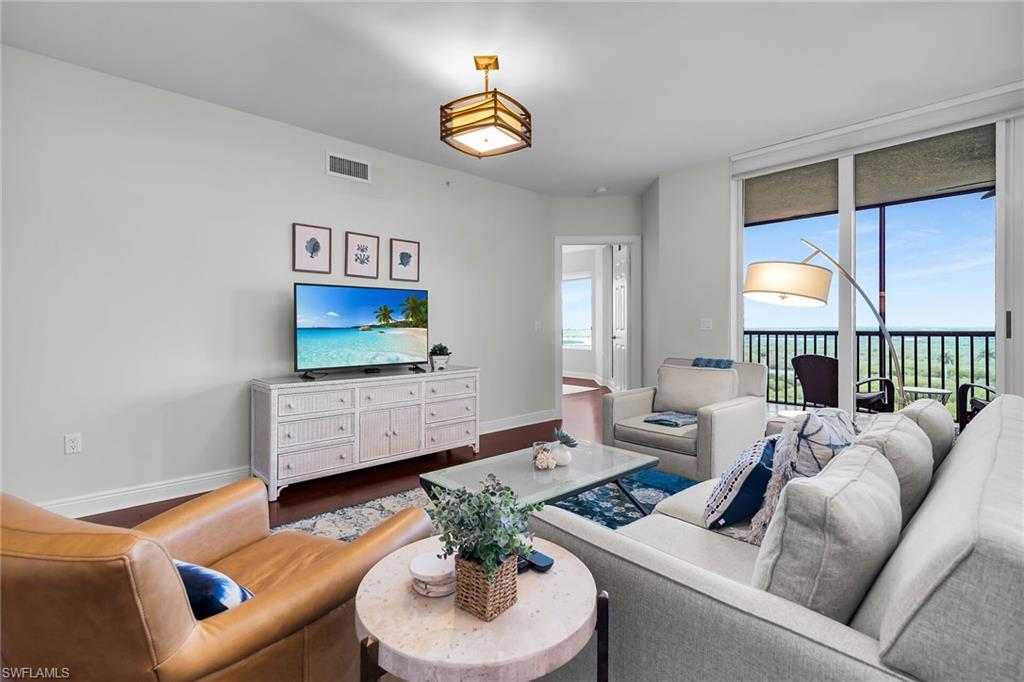 1065 Borghese Lane, Unit 1003 Naples, FL 34114 - Photo 11 of 35 a living room with furniture and a flat screen tv