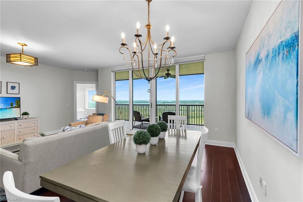 1065 Borghese Lane, Unit 1003 Naples, FL 34114 - Photo 12 of 35 a view of a dining room with furniture a chandelier and large windows
