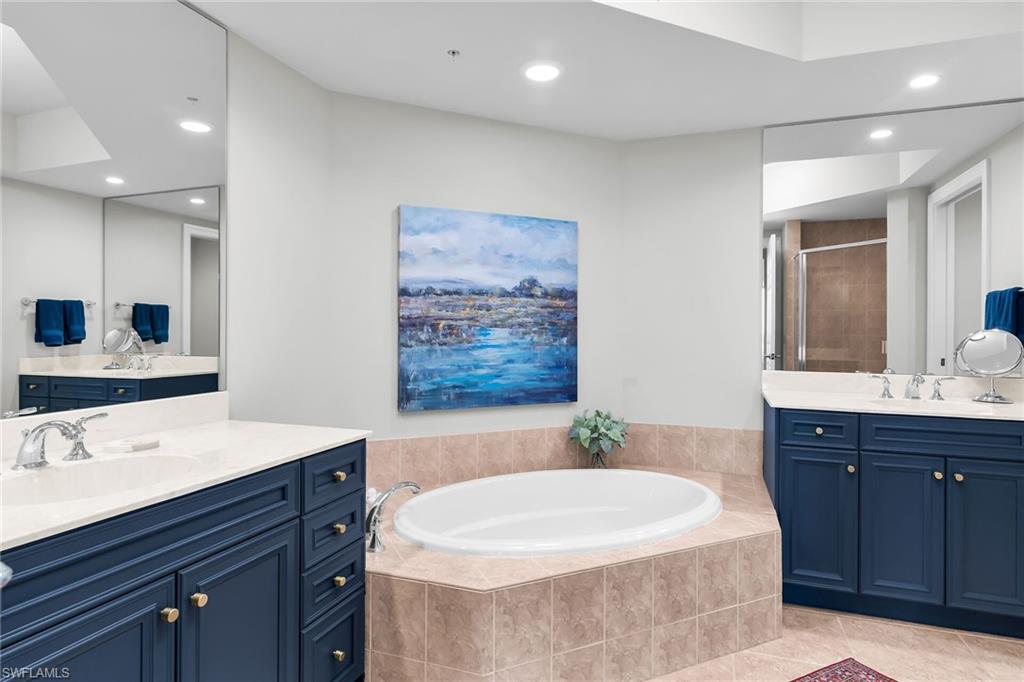 1065 Borghese Lane, Unit 1003 Naples, FL 34114 - Photo 17 of 35 a bathroom with a double vanity sink mirror and bathtub