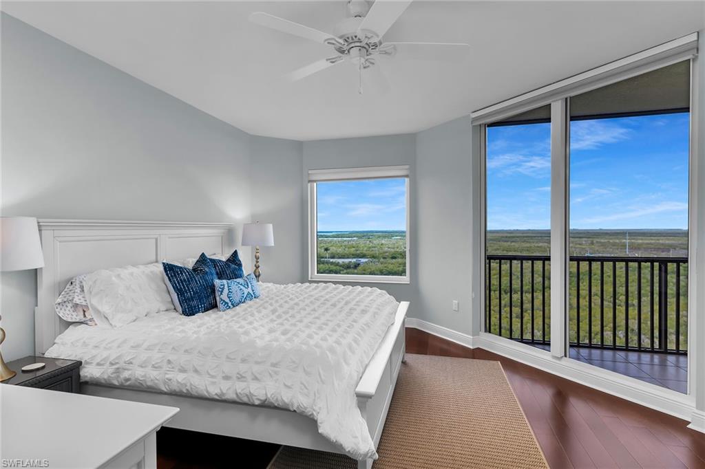 1065 Borghese Lane, Unit 1003 Naples, FL 34114 - Photo 19 of 35 a bedroom with a large bed and a large window