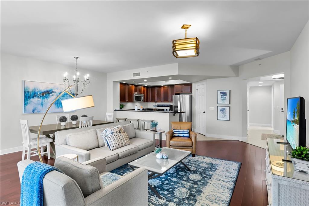 1065 Borghese Lane, Unit 1003 Naples, FL 34114 - Photo 20 of 35 a living room with furniture and a flat screen tv