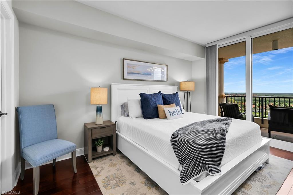 1065 Borghese Lane, Unit 1003 Naples, FL 34114 - Photo 24 of 35 a bedroom with bed and a night stand