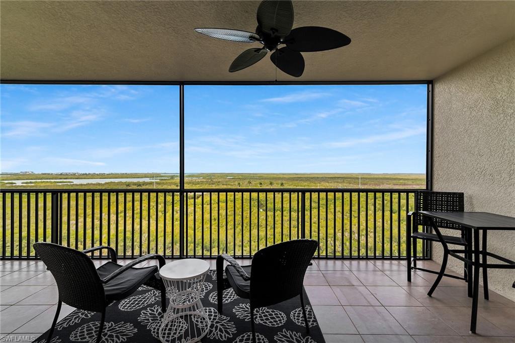 1065 Borghese Lane, Unit 1003 Naples, FL 34114 - Photo 27 of 35 a view of a chairs and table in the balcony