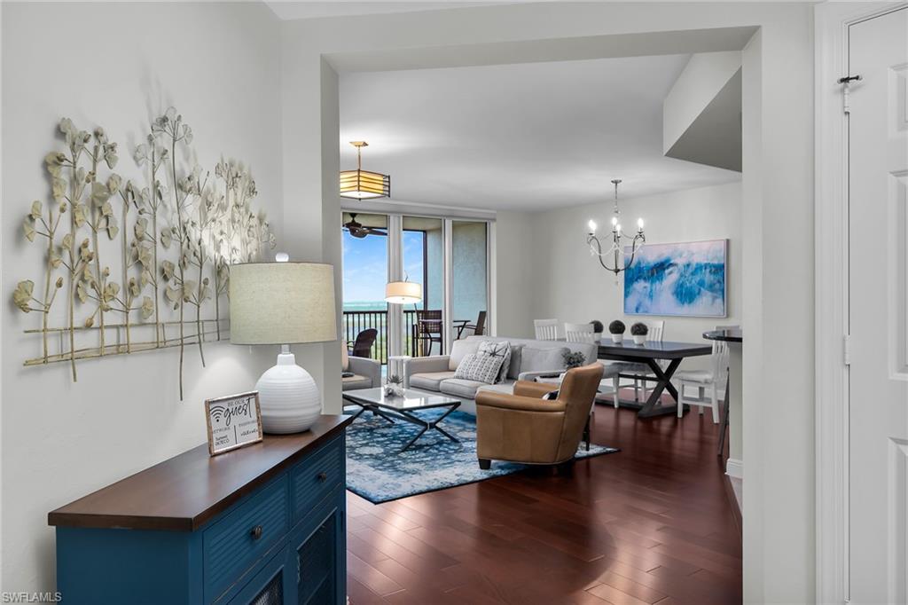 1065 Borghese Lane, Unit 1003 Naples, FL 34114 - Photo 3 of 35 a living room with furniture and a wooden floor