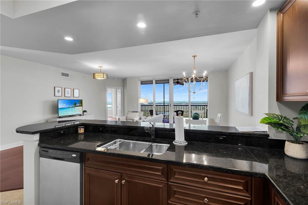 1065 Borghese Lane, Unit 1003 Naples, FL 34114 - Photo 7 of 35 a kitchen with a sink and stove