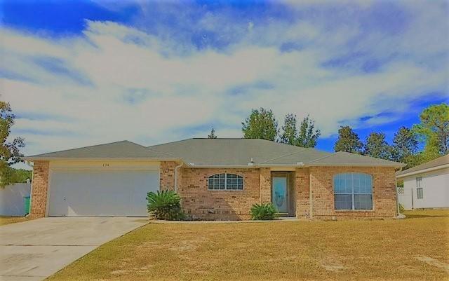 134 Sandstone Trail Crestview, FL 32539 - Photo 1 of 18 a front view of a house with a yard