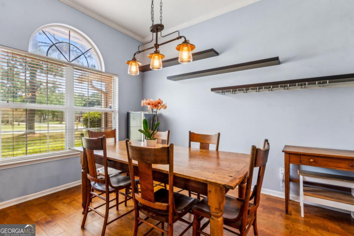 100 Longwood Road St. Marys, GA 31558 - Photo 11 of 39 a view of a dining room with furniture window and wooden floor