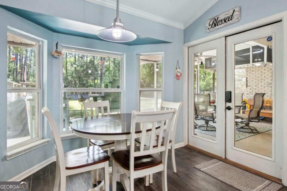 100 Longwood Road St. Marys, GA 31558 - Photo 14 of 39 a dining room with furniture a chandelier and wooden floor