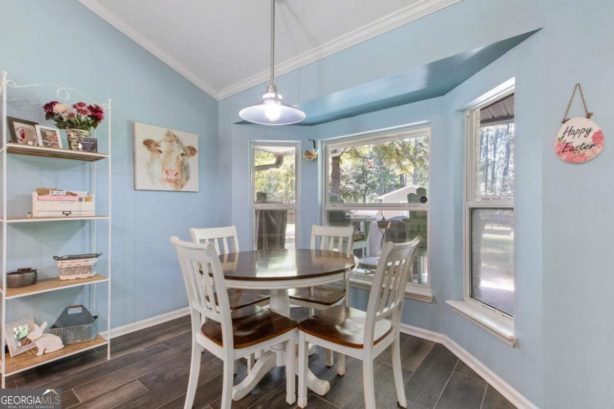 100 Longwood Road St. Marys, GA 31558 - Photo 15 of 39 a dining room with wooden floor and a window