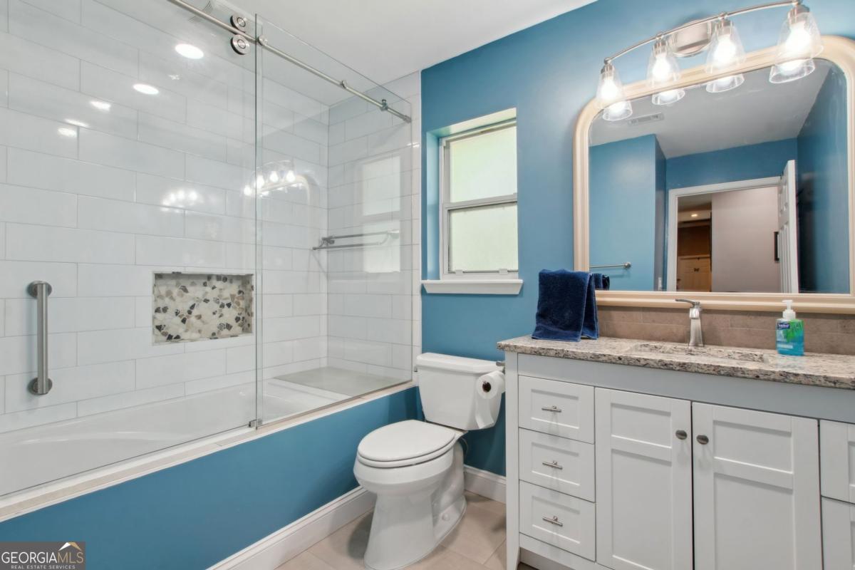100 Longwood Road St. Marys, GA 31558 - Photo 24 of 39 a bathroom with a granite countertop sink a toilet and a bathtub