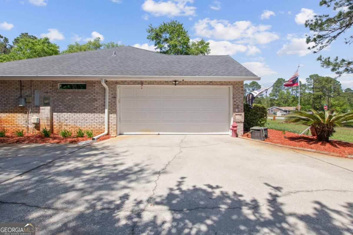 100 Longwood Road St. Marys, GA 31558 - Photo 36 of 39 a house with a yard and a garage