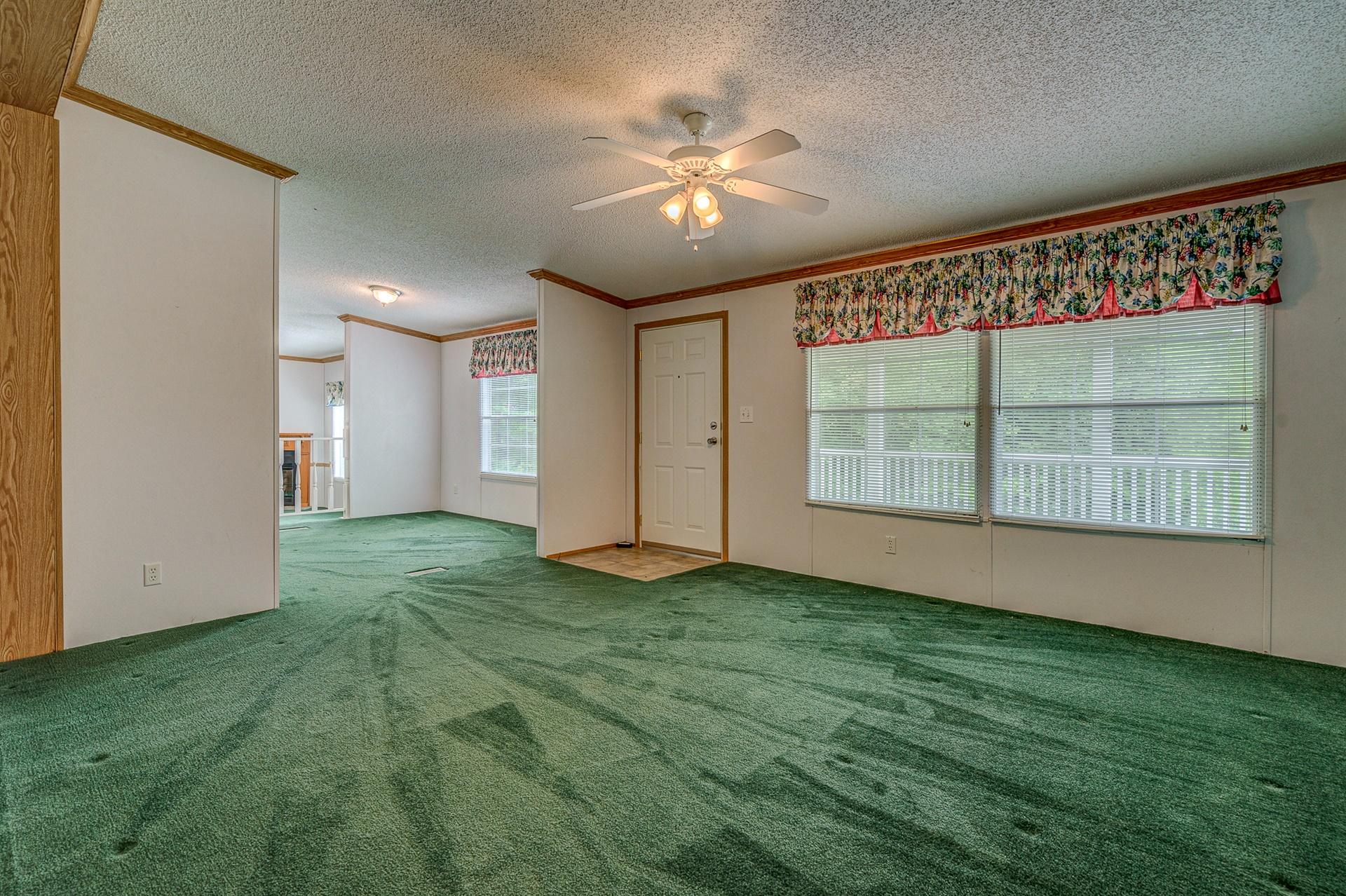 2930 Runnett Bag Road Ferrum, VA 24088 - Photo 6 of 42 a view of an empty room with window and chandelier fan