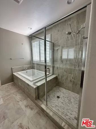 a bathroom with a shower and mirror