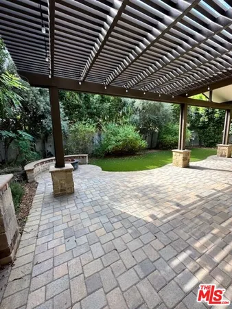 a patio with a patio table and chairs