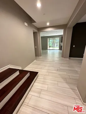 a view of room with window and wooden floor