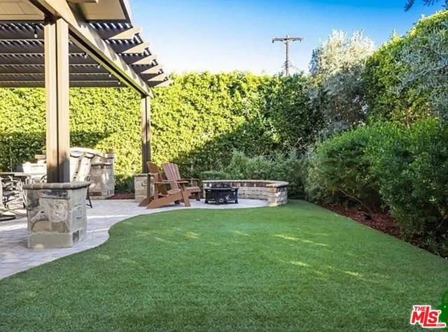 a view of a patio with table and chairs and potted plants