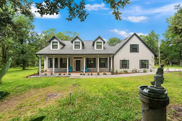 a front view of a house with a garden and porch