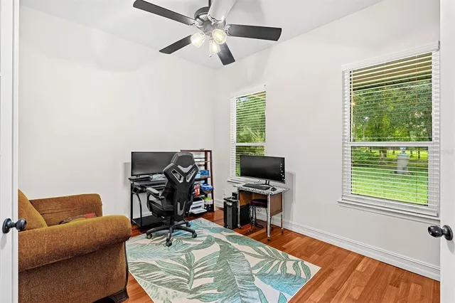 a living room with furniture a large window with kitchen view