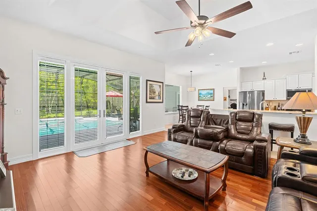 a kitchen with stainless steel appliances granite countertop a stove top oven a refrigerator and white cabinets