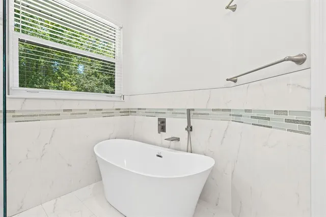 a view of a house with backyard sitting area and furniture