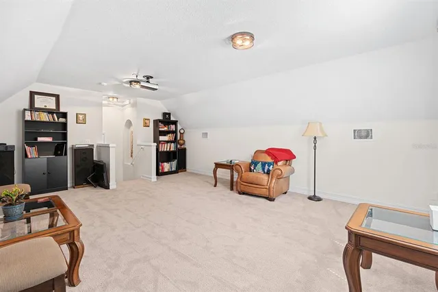 a view of a house with a yard and potted plants
