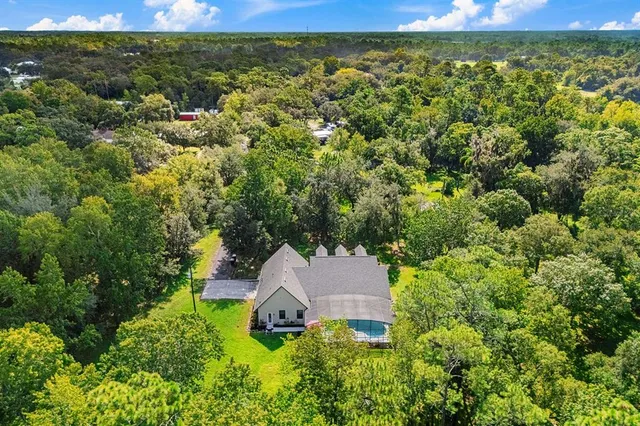 an aerial view of a house with yard and outdoor space