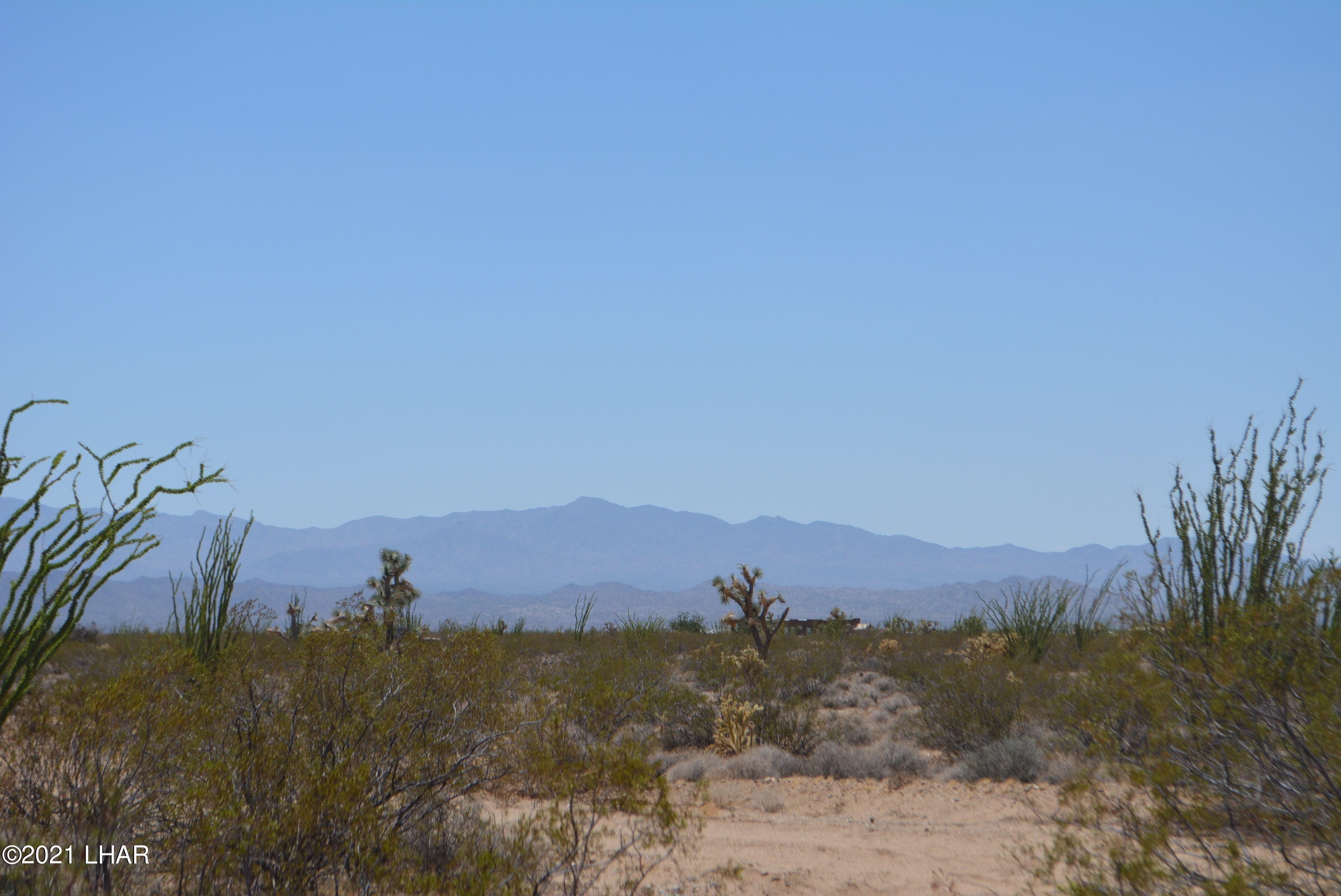 234 Cortaro Road Yucca, AZ 86438 - Photo 20 of 25 a view of a town with mountains in the background