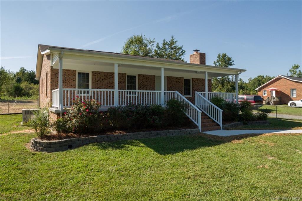 839 Sikes Mill Road Monroe, NC 28110 - Photo 1 of 26 a front view of a house with garden