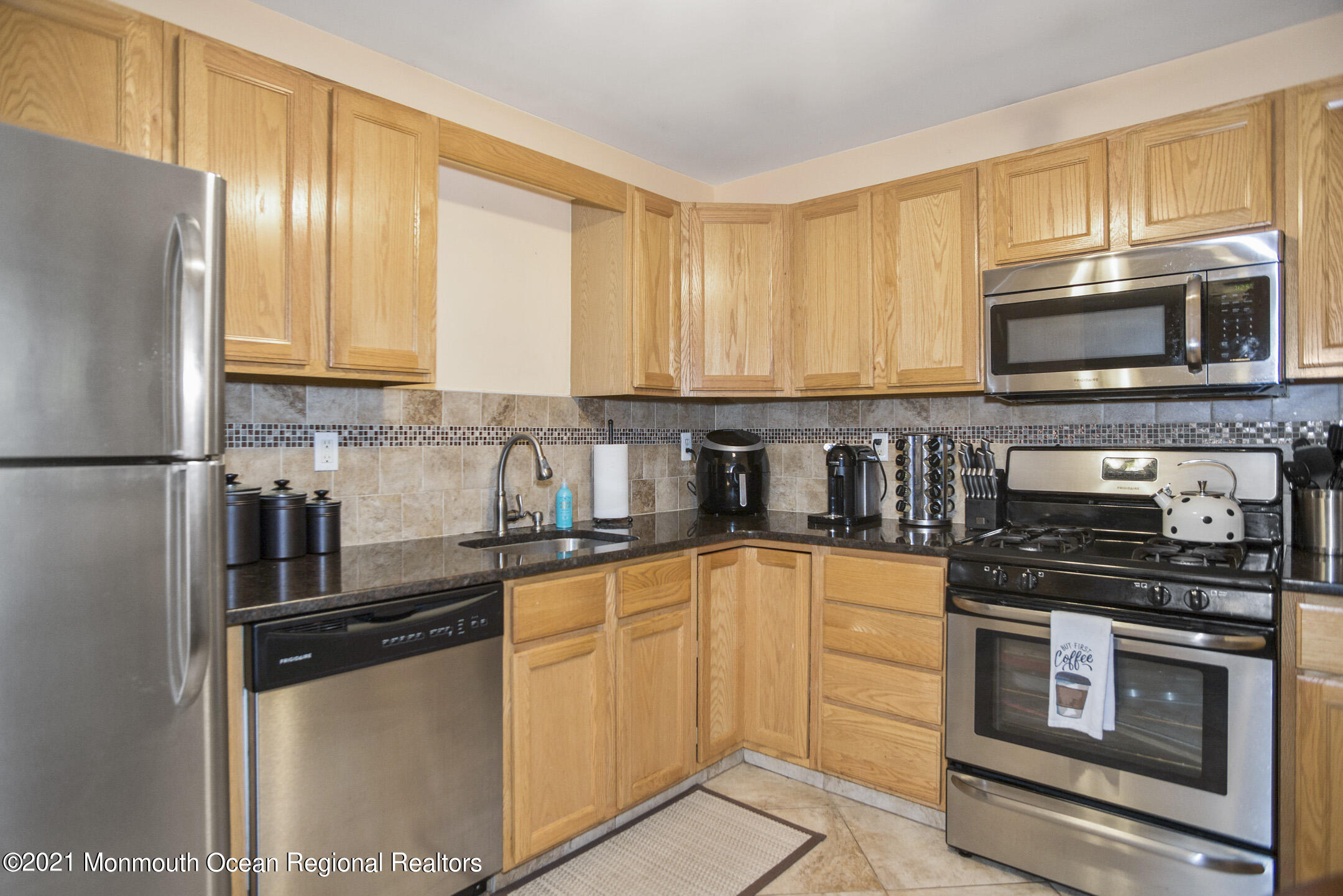 44 Prestwick Road Manalapan, NJ 07726 - Photo 8 of 15 a kitchen with stainless steel appliances granite countertop a stove a sink dishwasher a refrigerator and a microwave