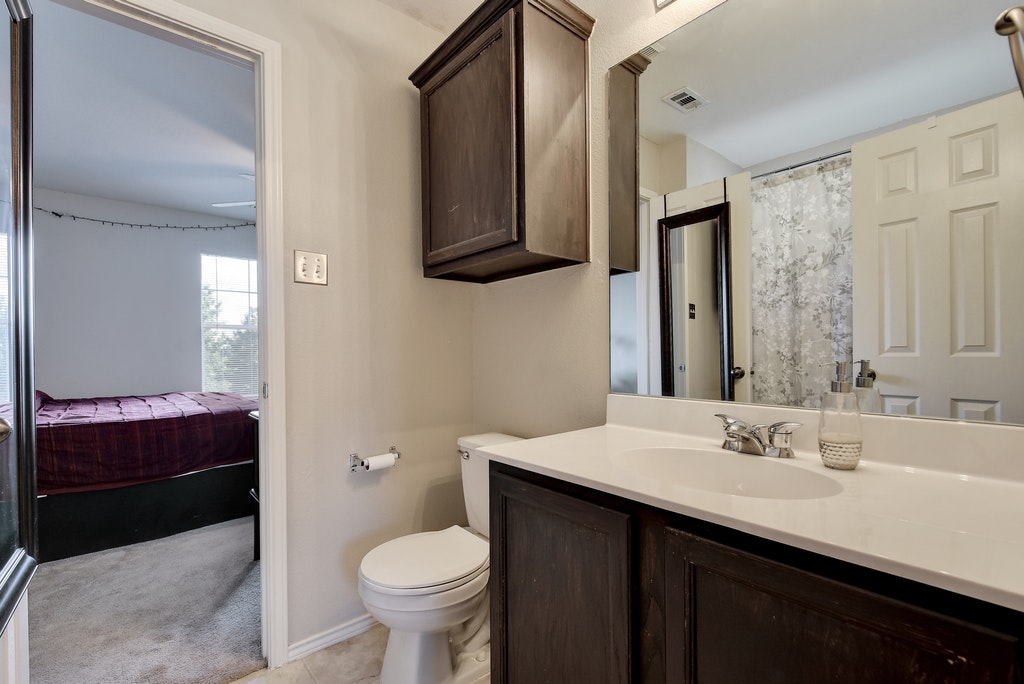 2201 Keepsake Drive Austin, TX 78745 - Photo 19 of 25 a bathroom with a sink and a mirror