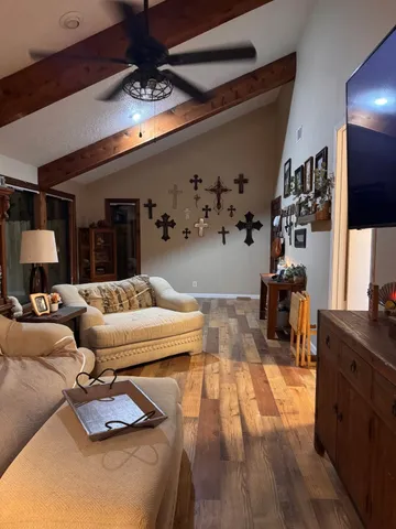 a living room with furniture and chandelier