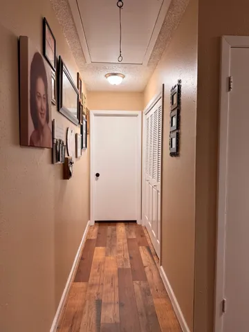a view of a hallway with wooden floor