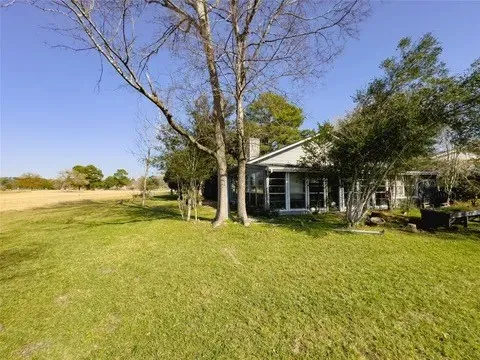 a view of a house with swimming pool and sitting area