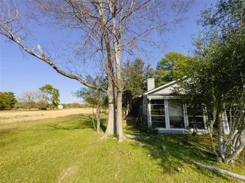 a view of a house with pool and garden