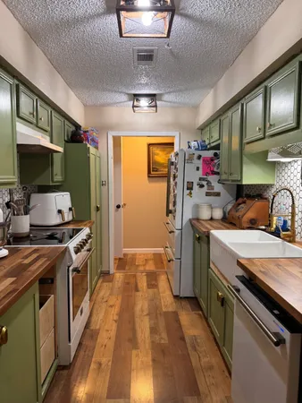a kitchen with a stove a sink and a refrigerator