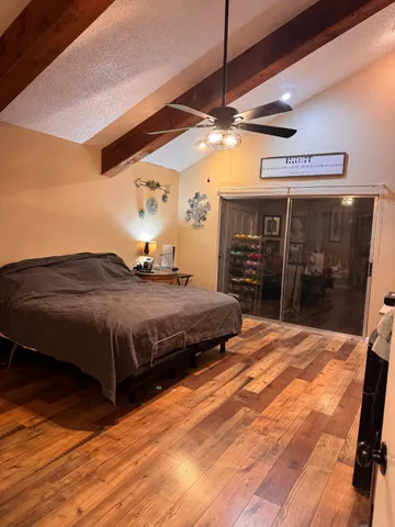 a bedroom with a bed mirror and a walk in closet