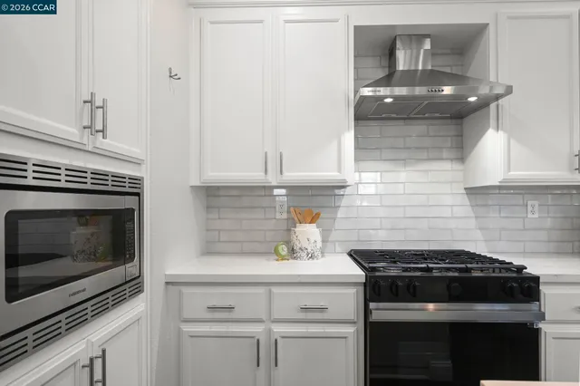 a kitchen with granite countertop a stove and a sink