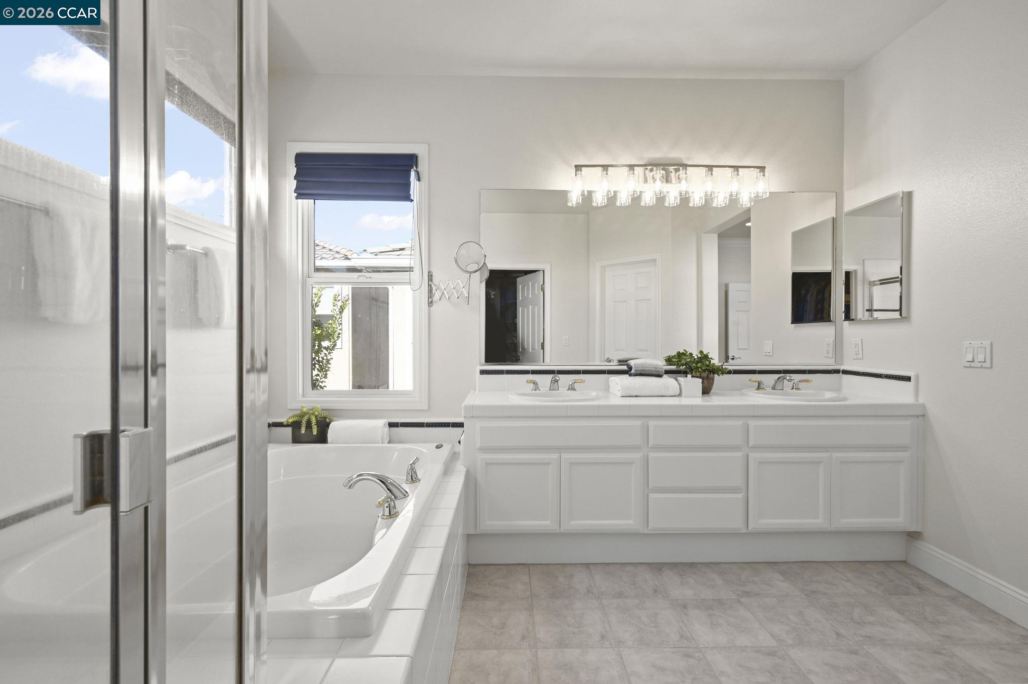 16 Poppy Hills Lane San Ramon, CA 94583 - Photo 19 of 30 a spacious bathroom with a double vanity sink a large mirror and shower