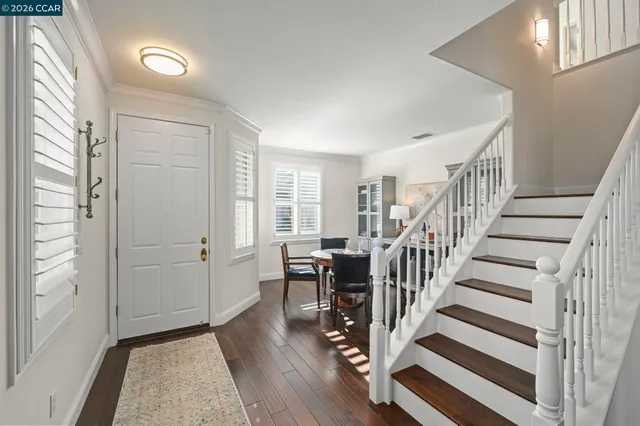 a view of entryway with wooden floor and stairs