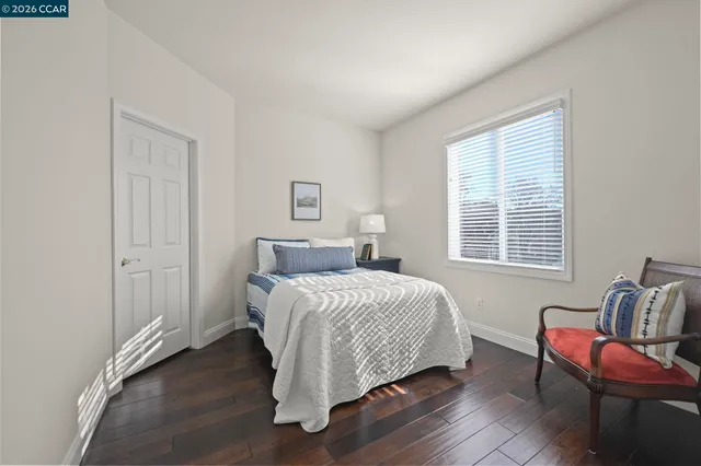 a bedroom with a bed and a chair