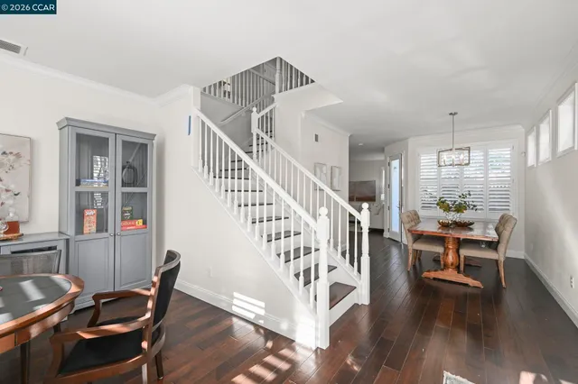 a view of a dining room with furniture wooden floor and next to a window
