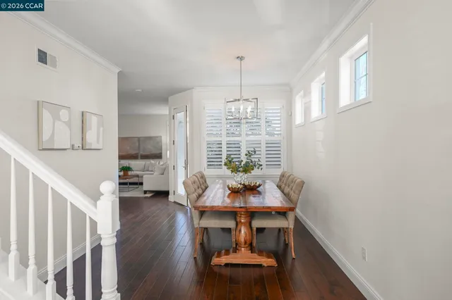 a dining room with furniture and wooden floor