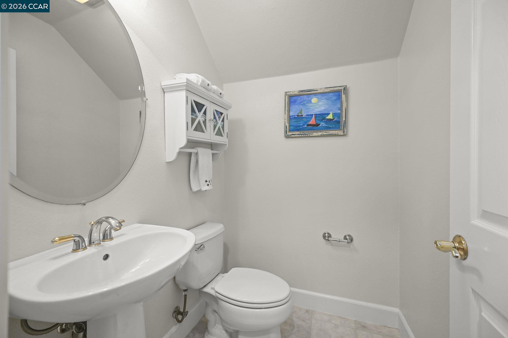 16 Poppy Hills Lane San Ramon, CA 94583 - Photo 6 of 30 a bathroom with a toilet a sink and mirror