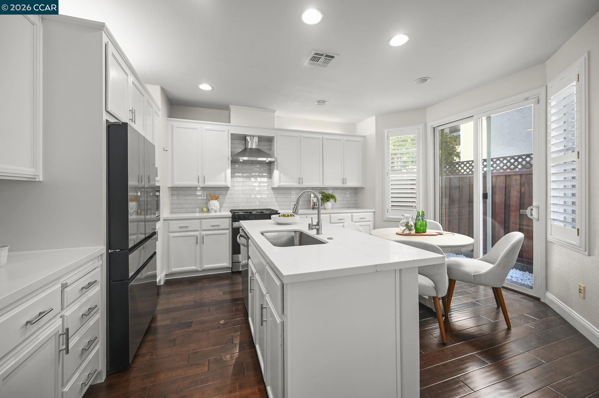 16 Poppy Hills Lane San Ramon, CA 94583 - Photo 10 of 30 a kitchen with a sink a stove a refrigerator and white cabinets