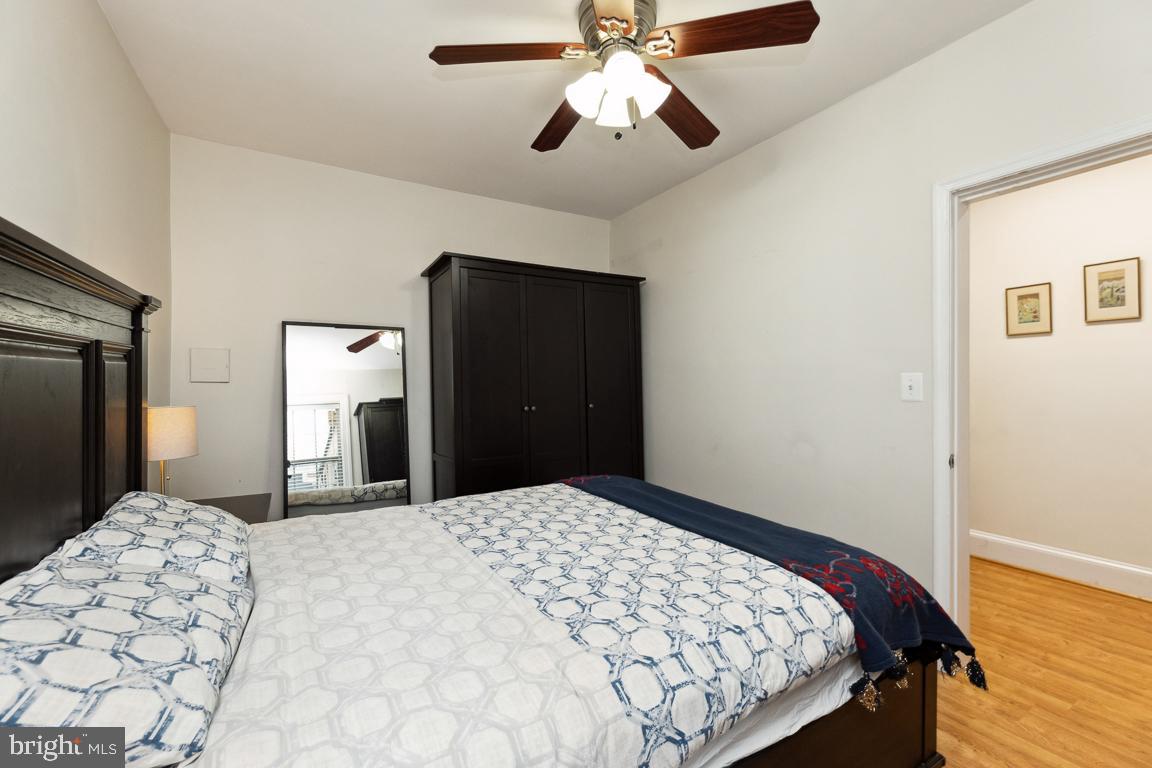 428 8th Street Southeast, Unit A Washington, DC 20003 - Photo 13 of 23 a bedroom with a bed and a chandelier