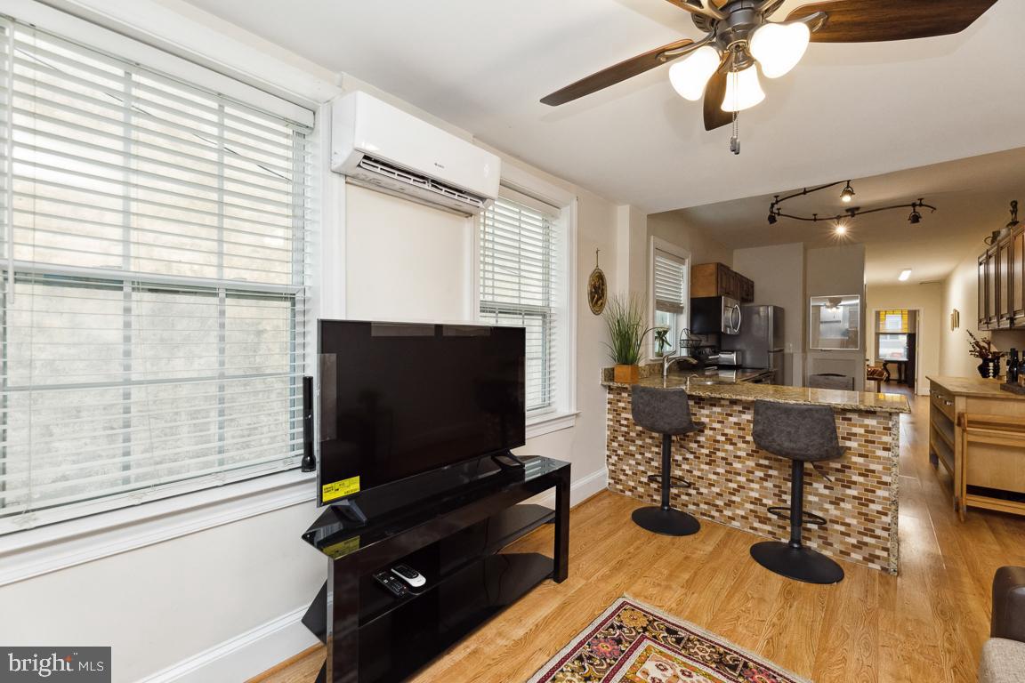 428 8th Street Southeast, Unit A Washington, DC 20003 - Photo 19 of 23 a living room with fireplace furniture and a flat screen tv
