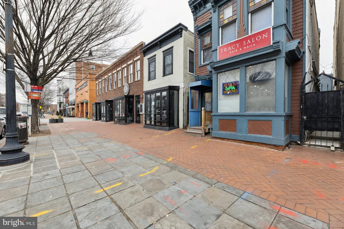 428 8th Street Southeast, Unit A Washington, DC 20003 - Photo 23 of 23 a street corner with retail shops and cars parked on road