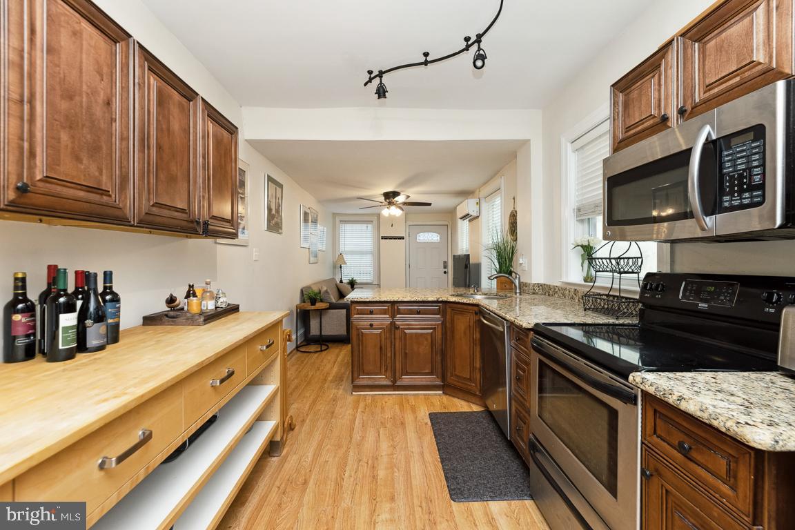 428 8th Street Southeast, Unit A Washington, DC 20003 - Photo 3 of 23 a kitchen with stainless steel appliances granite countertop a stove and cabinets