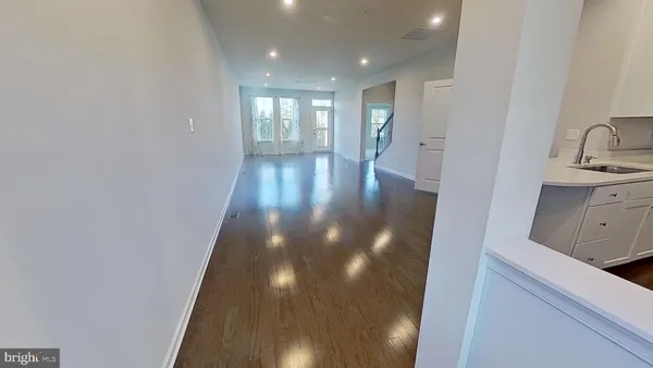 a view of hallway with wooden floor