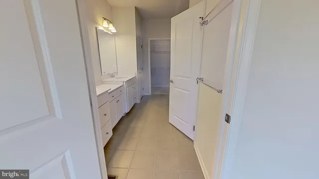 a bathroom with a double vanity sink and a mirror